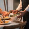 A Thanksgiving feast being laid out on a table